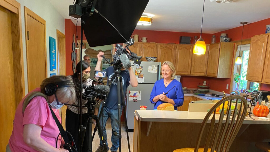 A camera crew films Susan Apps-Bodilly in her kitchen