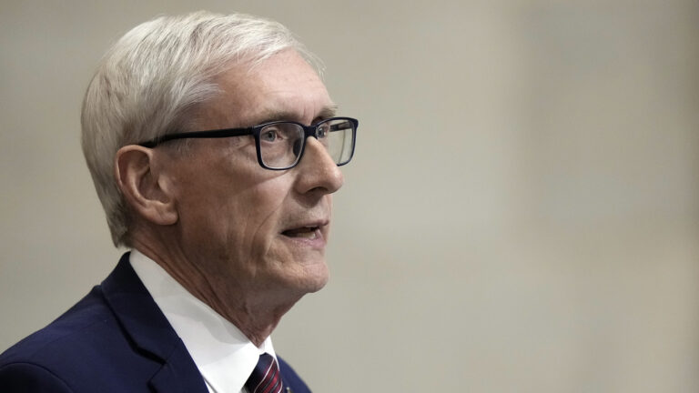 Tony Evers is pictured in profile while speaking.