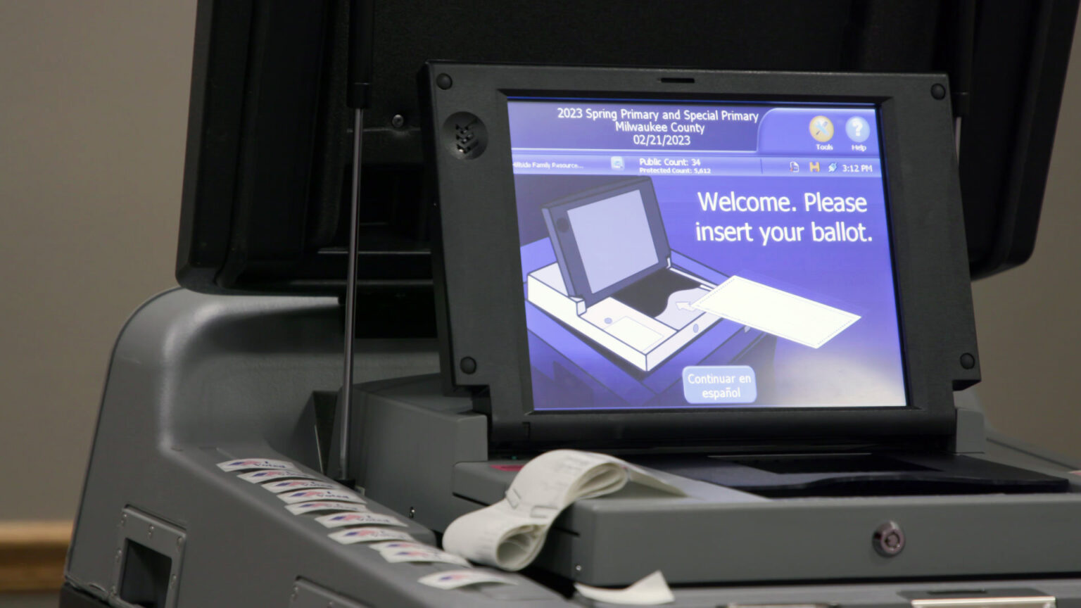 A screen on a ballot tabulator machine shows an illustration that demonstrates how to insert a ballot and includes the words 2023 Spring Primary and Special Primary, Milwaukee County, 02/21/2023, with instructions reading Welcome. Please insert your ballot.