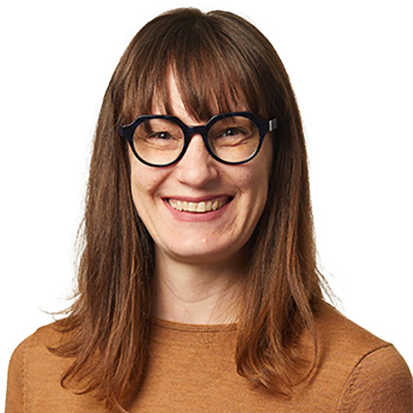 Portrait of a woman (Ariel Beaujot) wearing glasses and smiling.