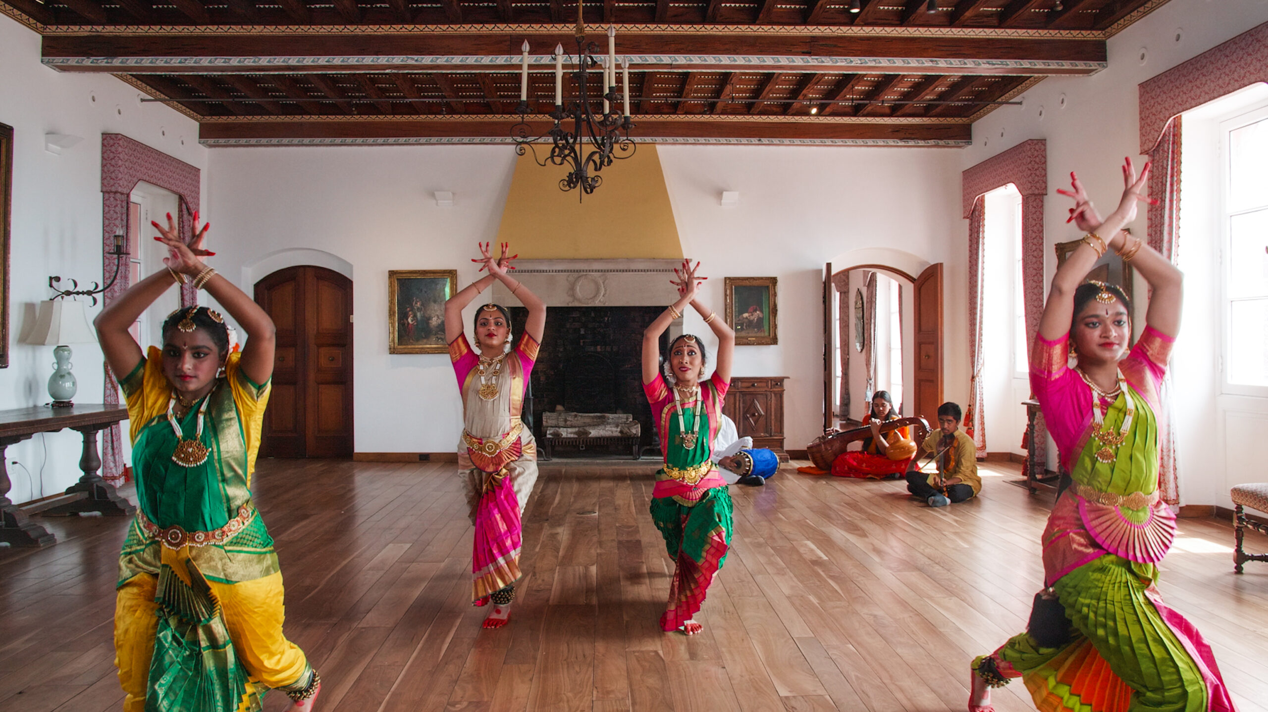 A group of people perform a Southern Indian classical music song and dance.