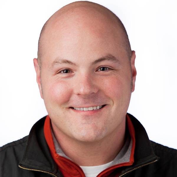 Portrait of a man (Patrick Farabaugh) looking into the camera and smiling.