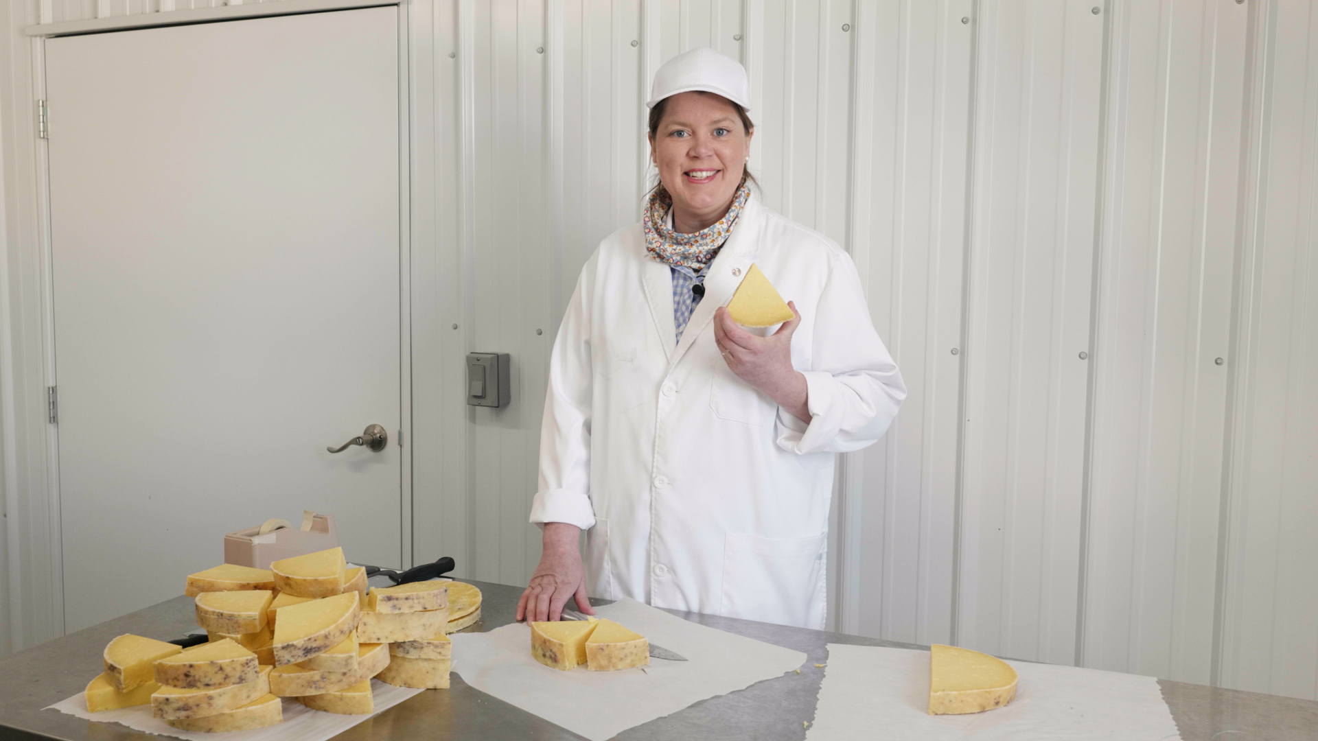 Inga Witscher holds a wedge of cheese.