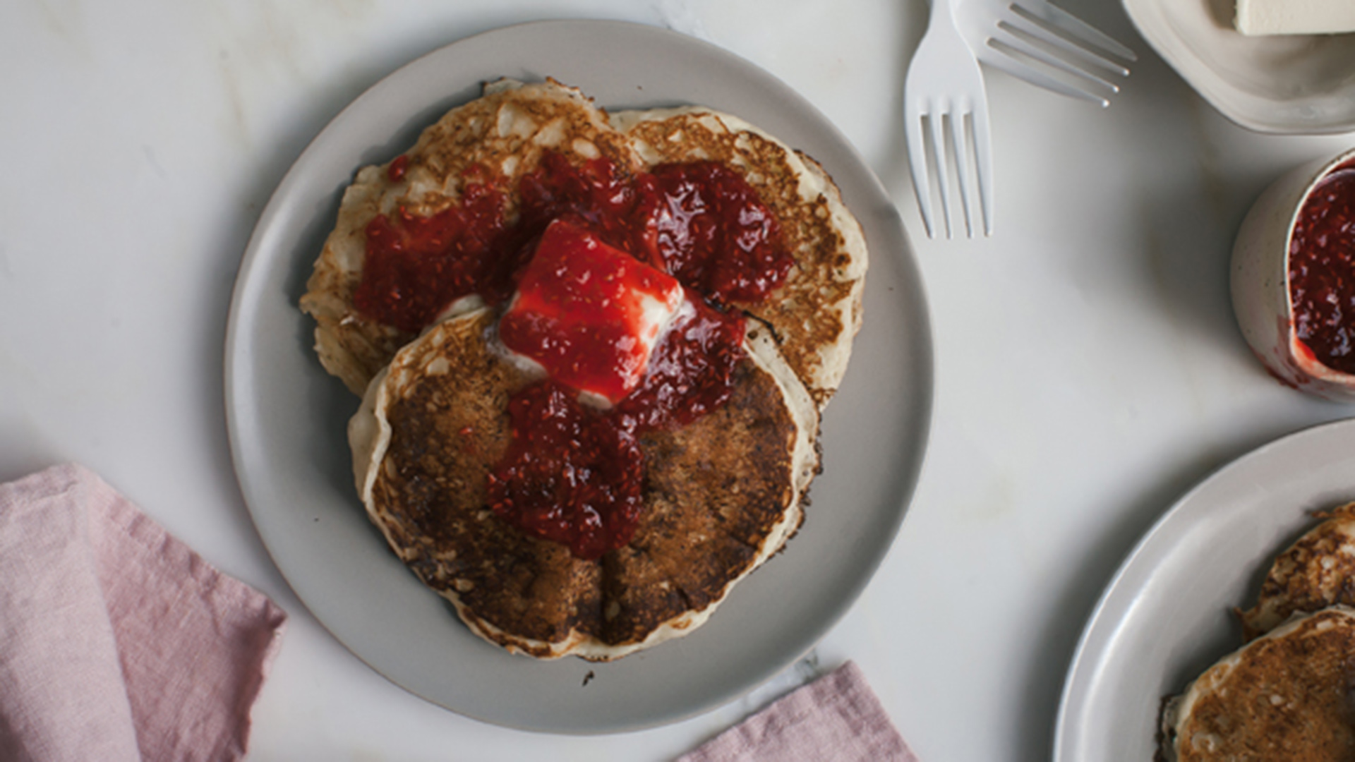 Pancakes with red raspberry sauce drizzle