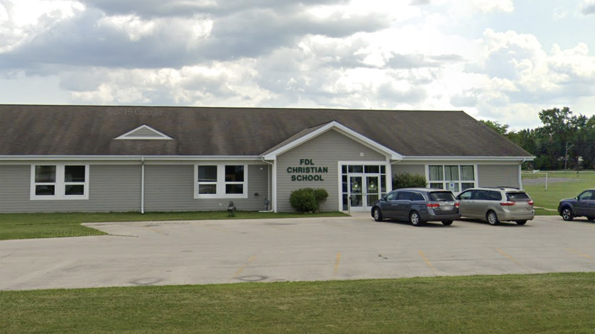 A Google Maps photo shows a one-story building with a sign reading "FDL Christian School," with multiple cars in a parking lot in the foreground.