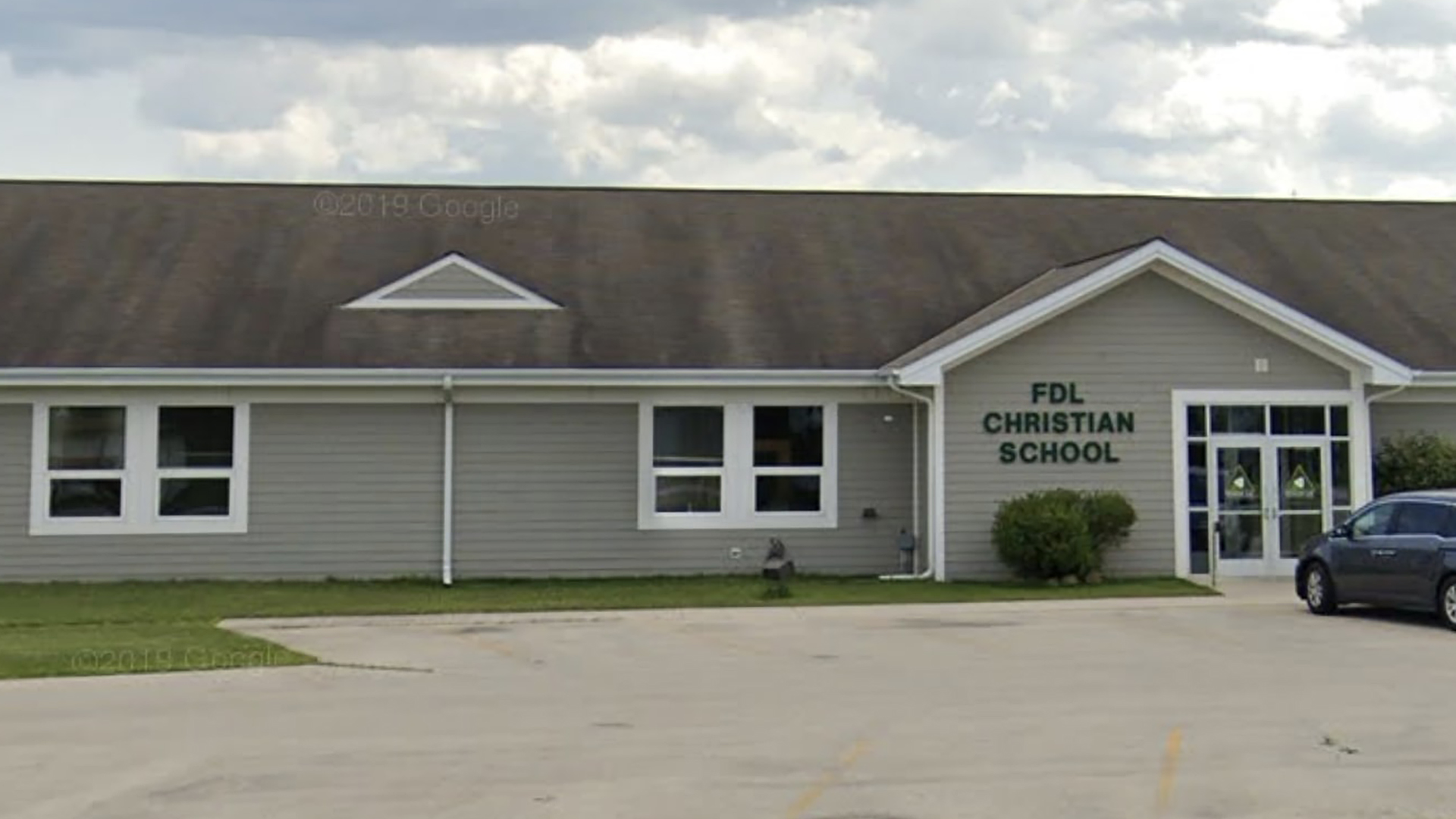 A Google Maps photo shows a one-story building with a sign reading "FDL Christian School," with a car in a parking lot in the foreground.