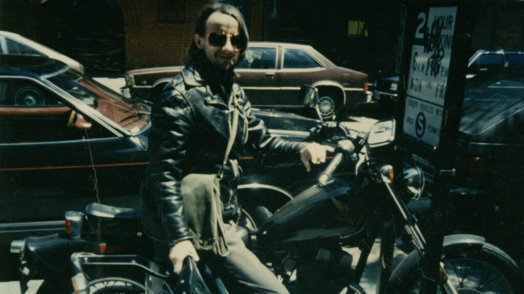 An archival image of Lou Sullivan on his motorcycle