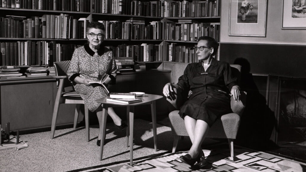 An archival photo of Miriam and Charlotte sitting in a private library