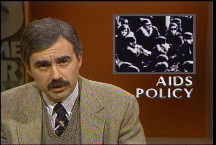 Wisconsin Magazine anchor Dave Iverson reports the news in front of a motion graphic that reads "AIDS policy"