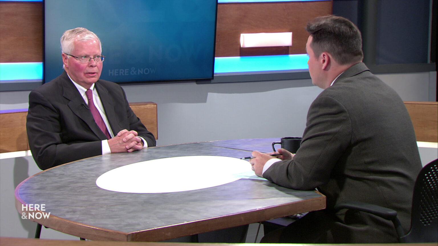 Zac Schultz and Jay Rothman sit at the studio desk facing each other.