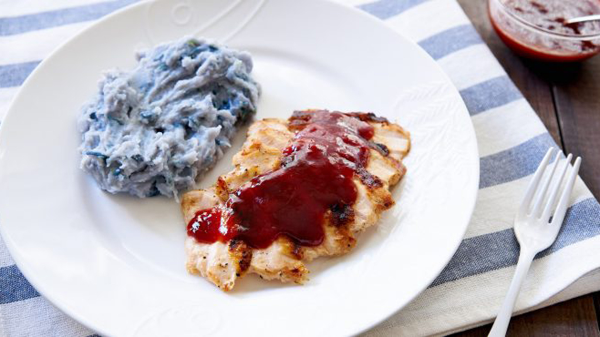 Grilled ribs slathered in red strawberry sauce.