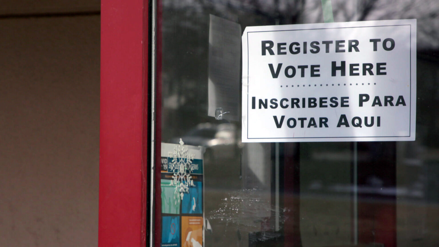A voting registration sign greets voters at the entrance to a polling place in Milwaukee on Feb. 21, 2023. (Credit: PBS Wisconsin)