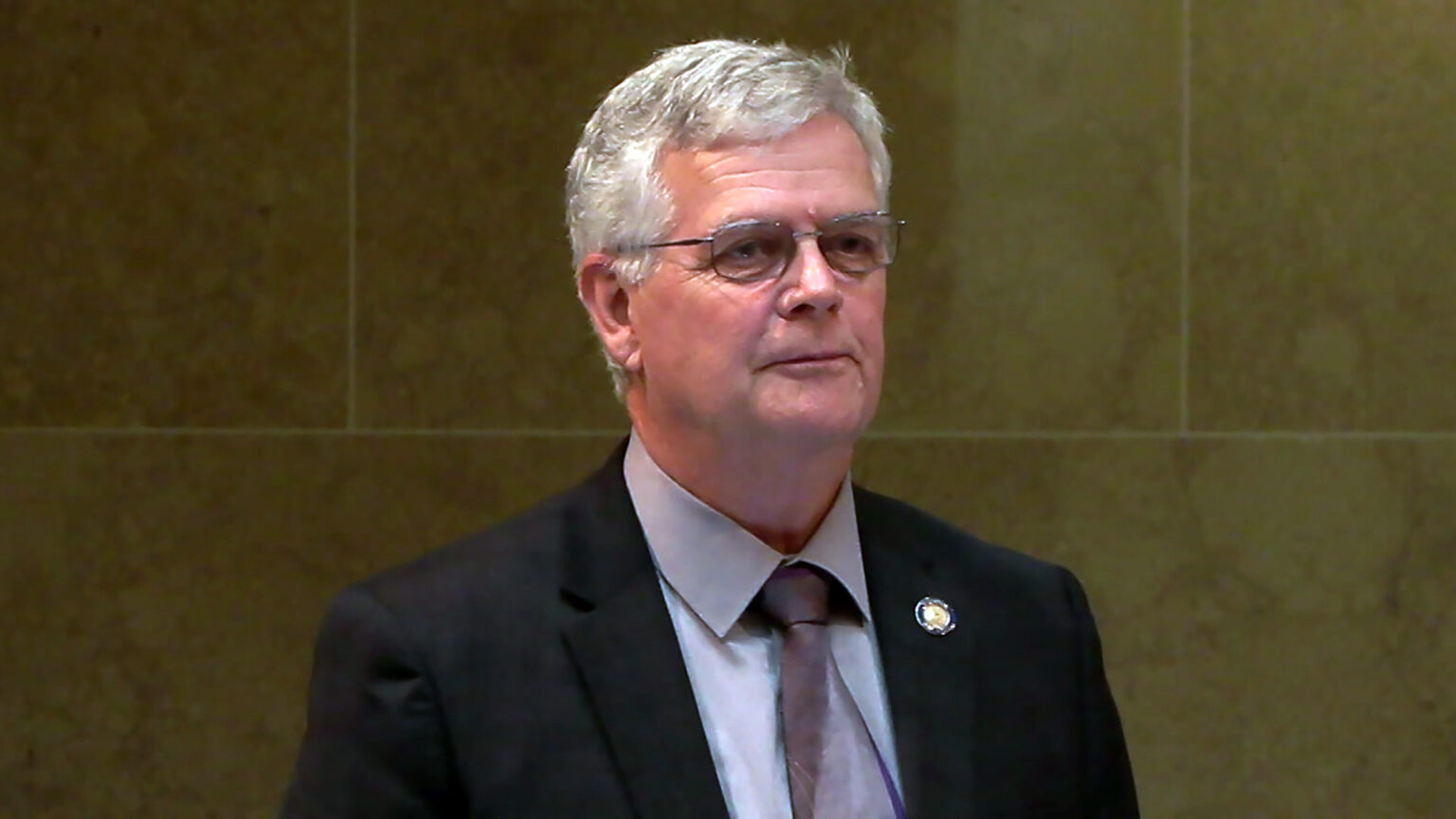 Jeff Smith stands in a room with marble masonry.