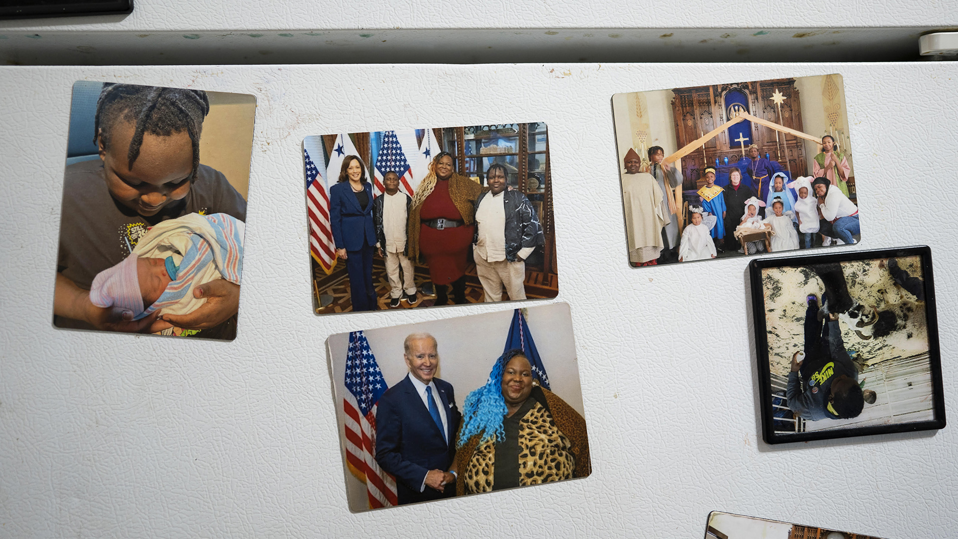 Multiple photos are attached to the surface of a refrigerator door, including one with Deanna Branch posing with Joe Biden and another with Branch and her family posing with Kamala Harris.