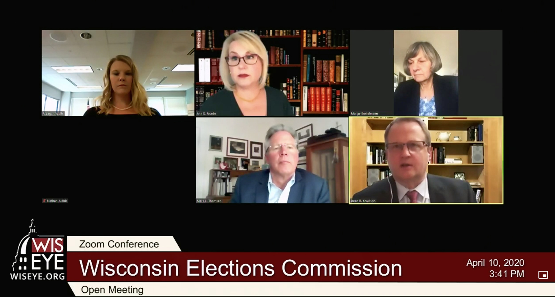 A screenshot shows a video conference with six different participants in different locations, with one having their camera turned off, with a video graphic at bottom reading "Wisconsin Elections Commission," "Open Meeting" and "April 10, 2020."
