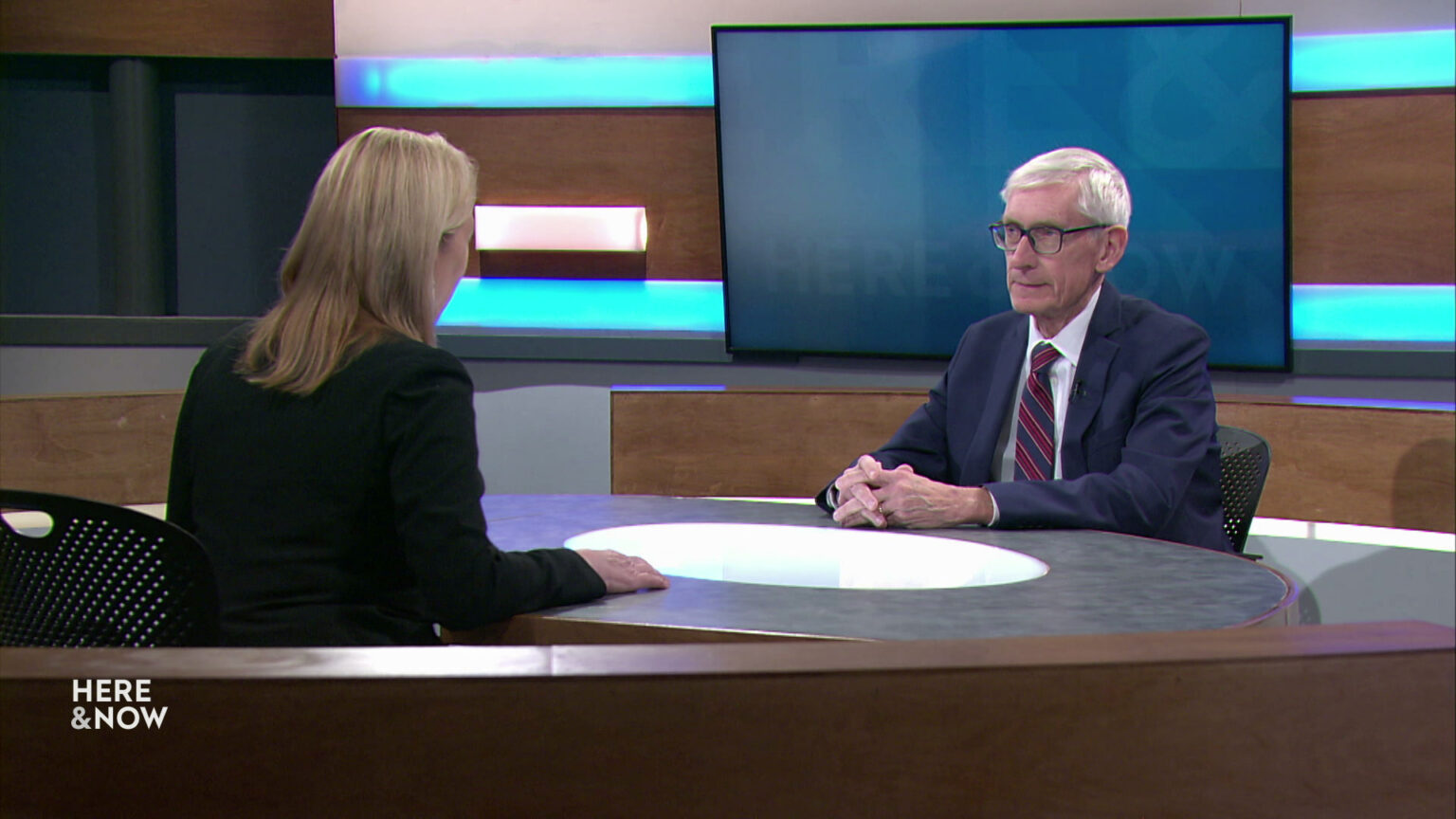 Frederica Freyberg and Tony Evers sit facing each other on the Here & Now set.