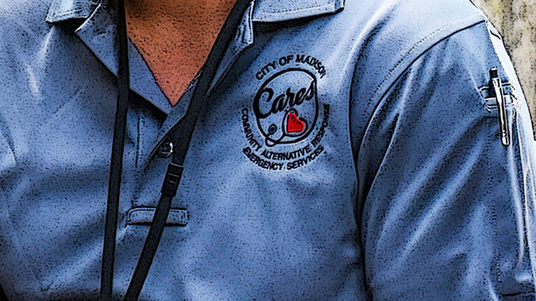 A posterized photo illustration shows a logo with a heart and stethoscope along with the words City of Madison, CARES, and Community Alternative Response Emergency Services, on the left breast of of a polo shirt, with a pen tucked into a pocket on the left shoulder.