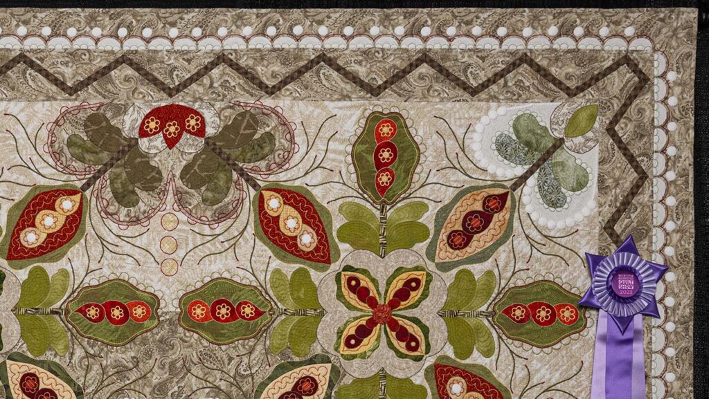 Upper right-hand corner of "The Crossing," a traditional, warm-toned quilt embellished with white circles throughout.