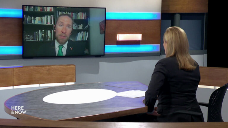 Freyberg sits on set with state Sen. Chris Larson in a TV monitor.