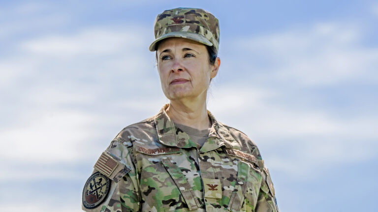 Leslie Zyzda Martin poses for a portrait while wearing a combat uniform.