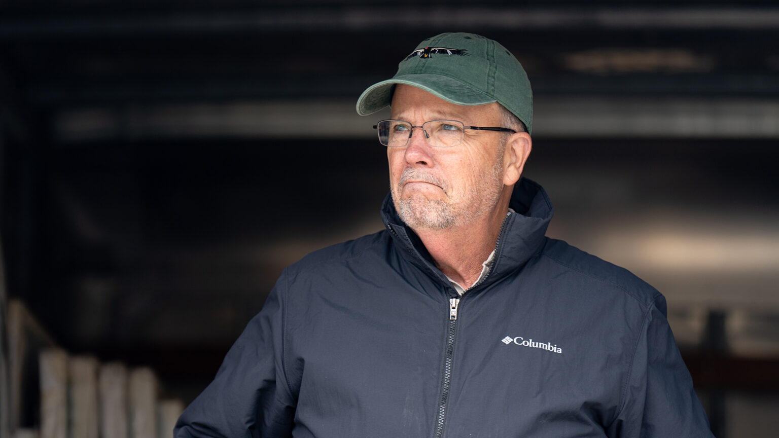 Matthew Trewhella stands outside in front of the cargo area of a moving truck.