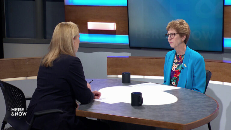 Frederica Freyberg and Linda Hall sit facing each other on the Here & Now set.