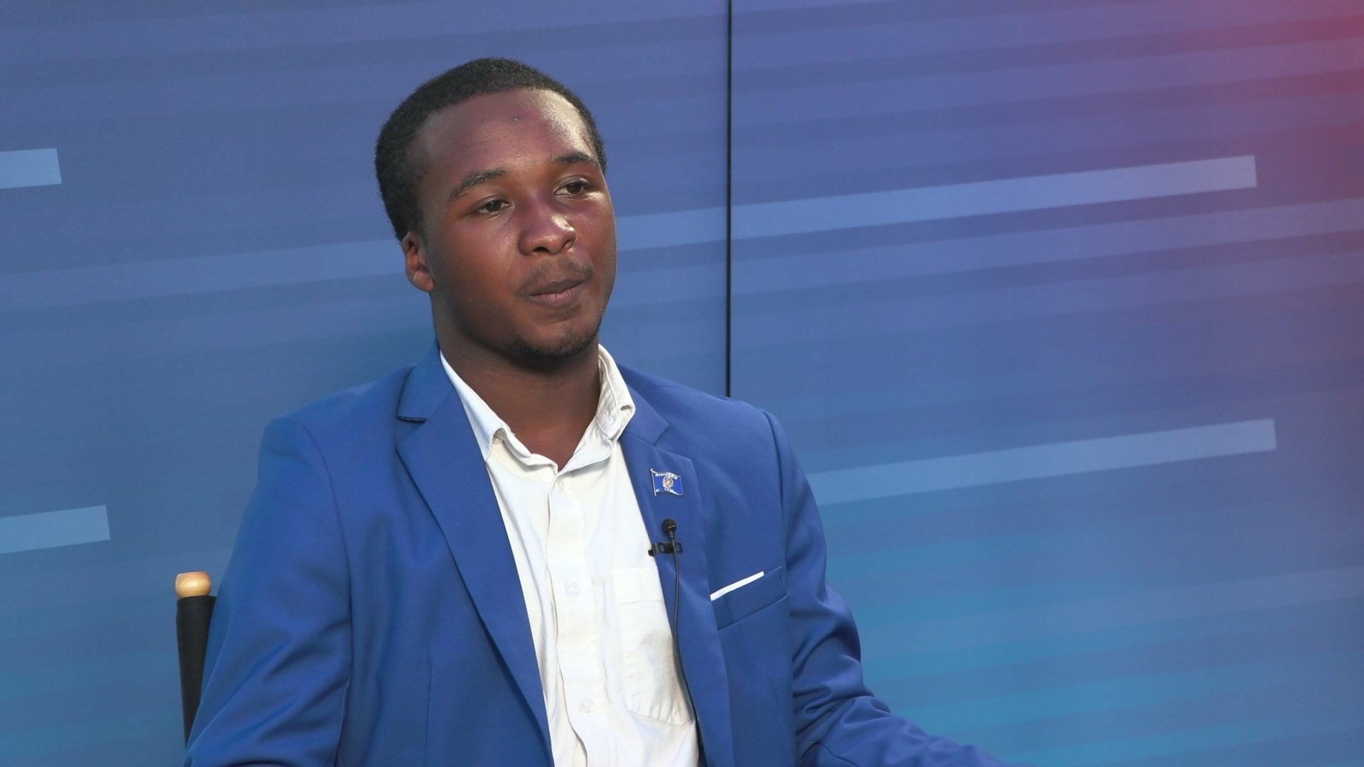 Landiran Kern, Jr. speaks while sitting in front of a gradient background set graphic.