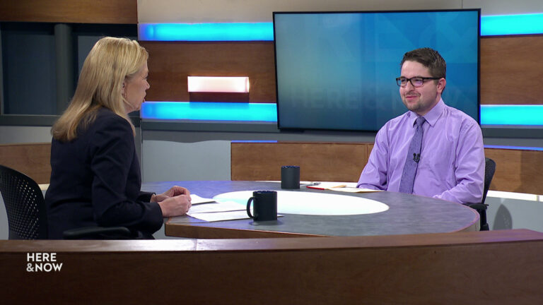 Frederica Freyberg and Anthony Chergosky sit facing each other on the Here & Now set.