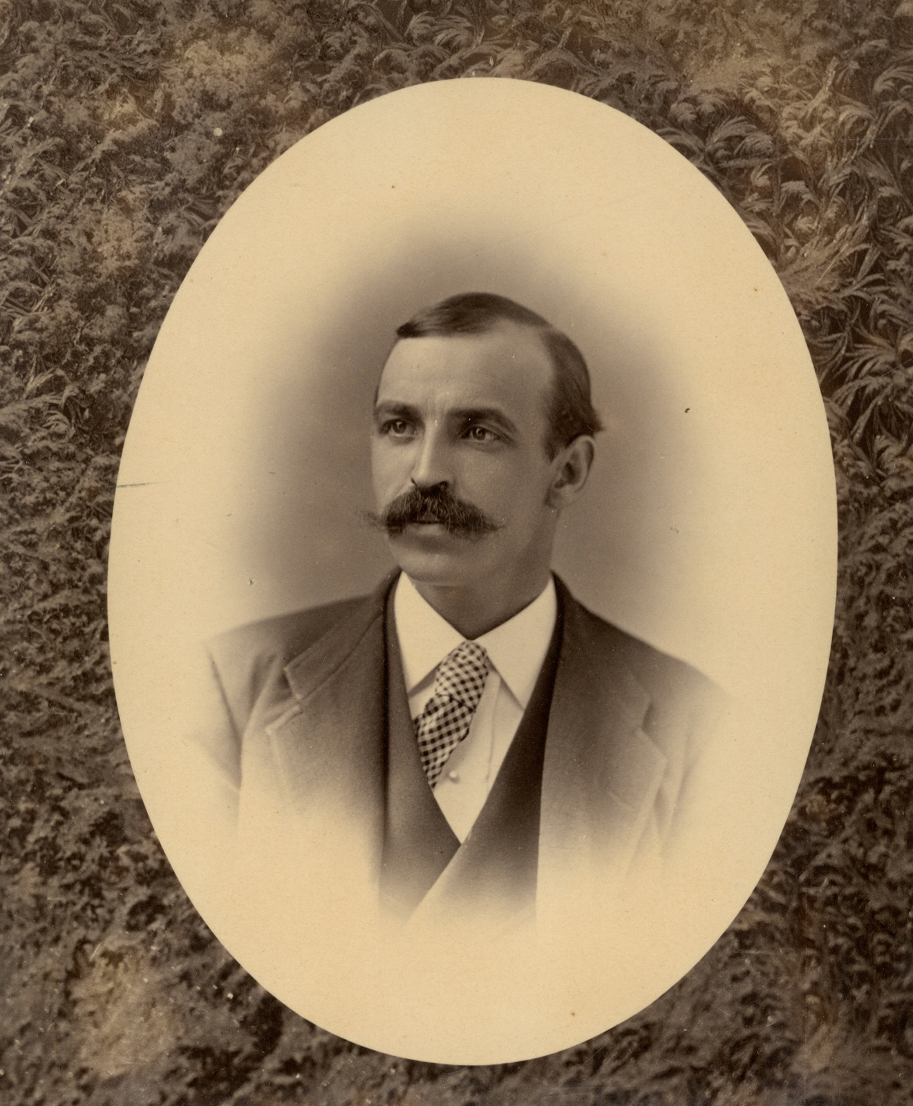 A sepia print shows a portrait of William Goodhue within an oval matte.