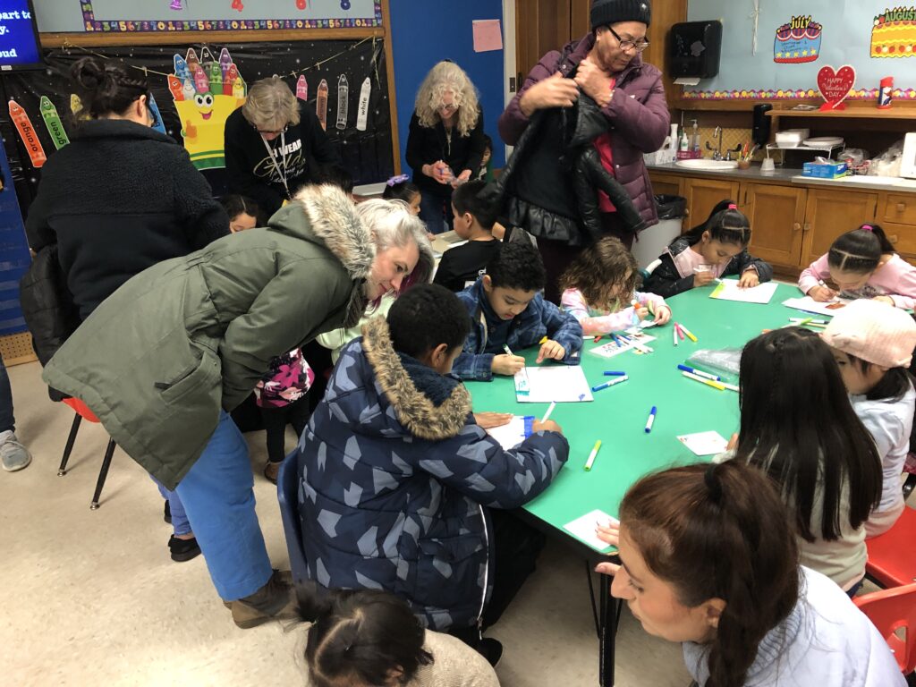 children and adults working at a table