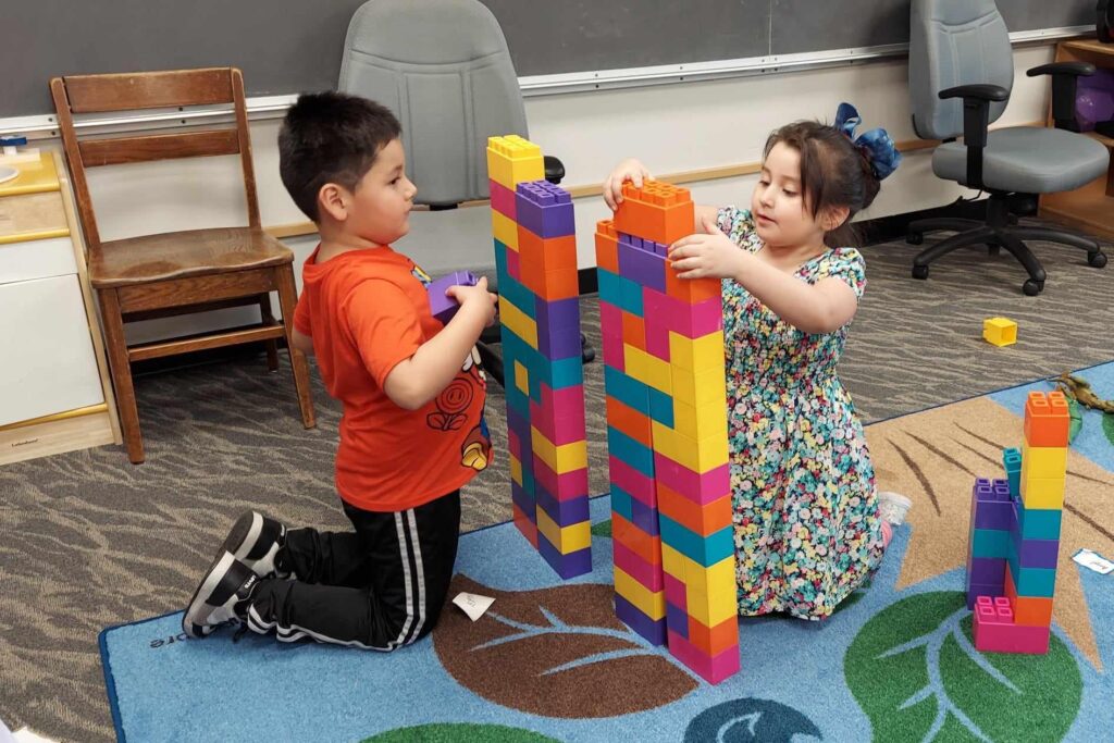 Two children stacking blocks