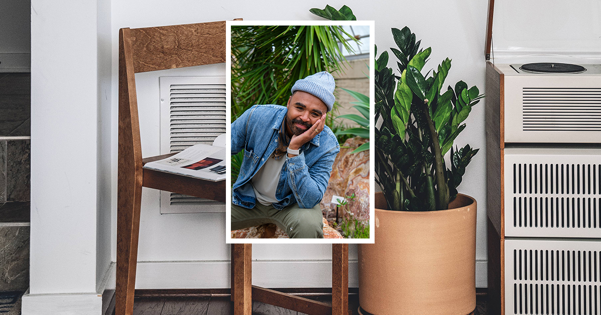 A man in a chair wearing a beanie and denim jacket is overlayed over a flourishing plant, contributing to a peaceful and inviting environment.