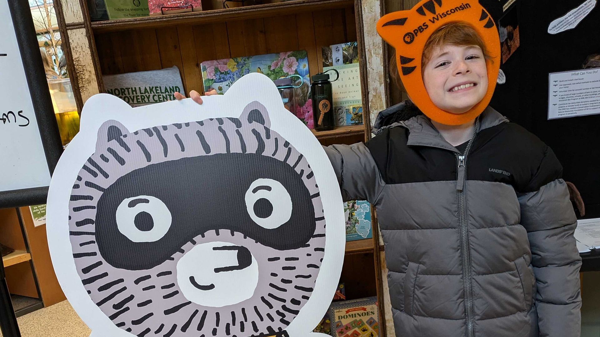 A child strikes a pose with Carl the Collector at the launch party in Manitowish Waters. (Source: PBS Wisconsin)