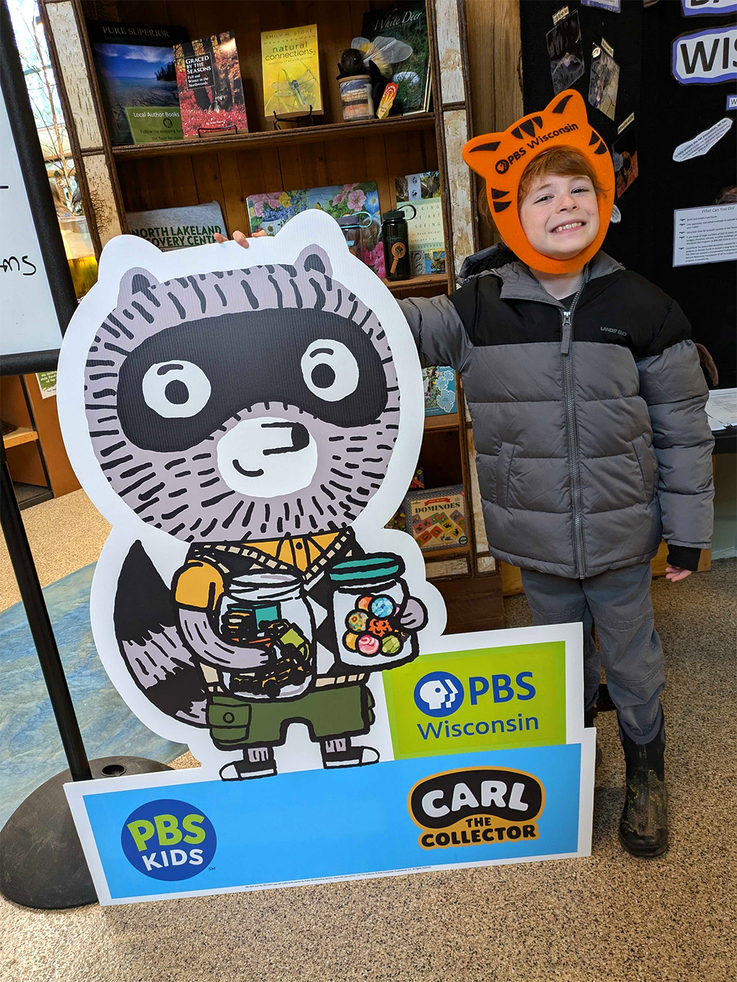 A child strikes a pose with Carl the Collector at the launch party in Manitowish Waters. (Source: PBS Wisconsin)