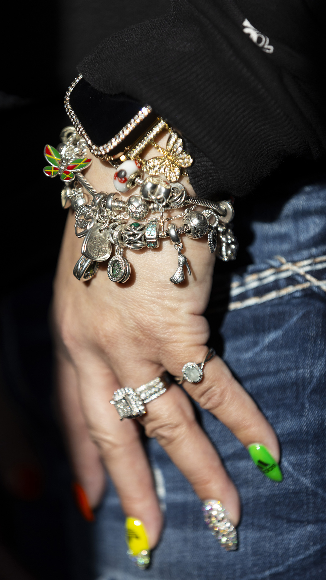 A bracelet with multiple charms rests on Desilynn Smith's hand.