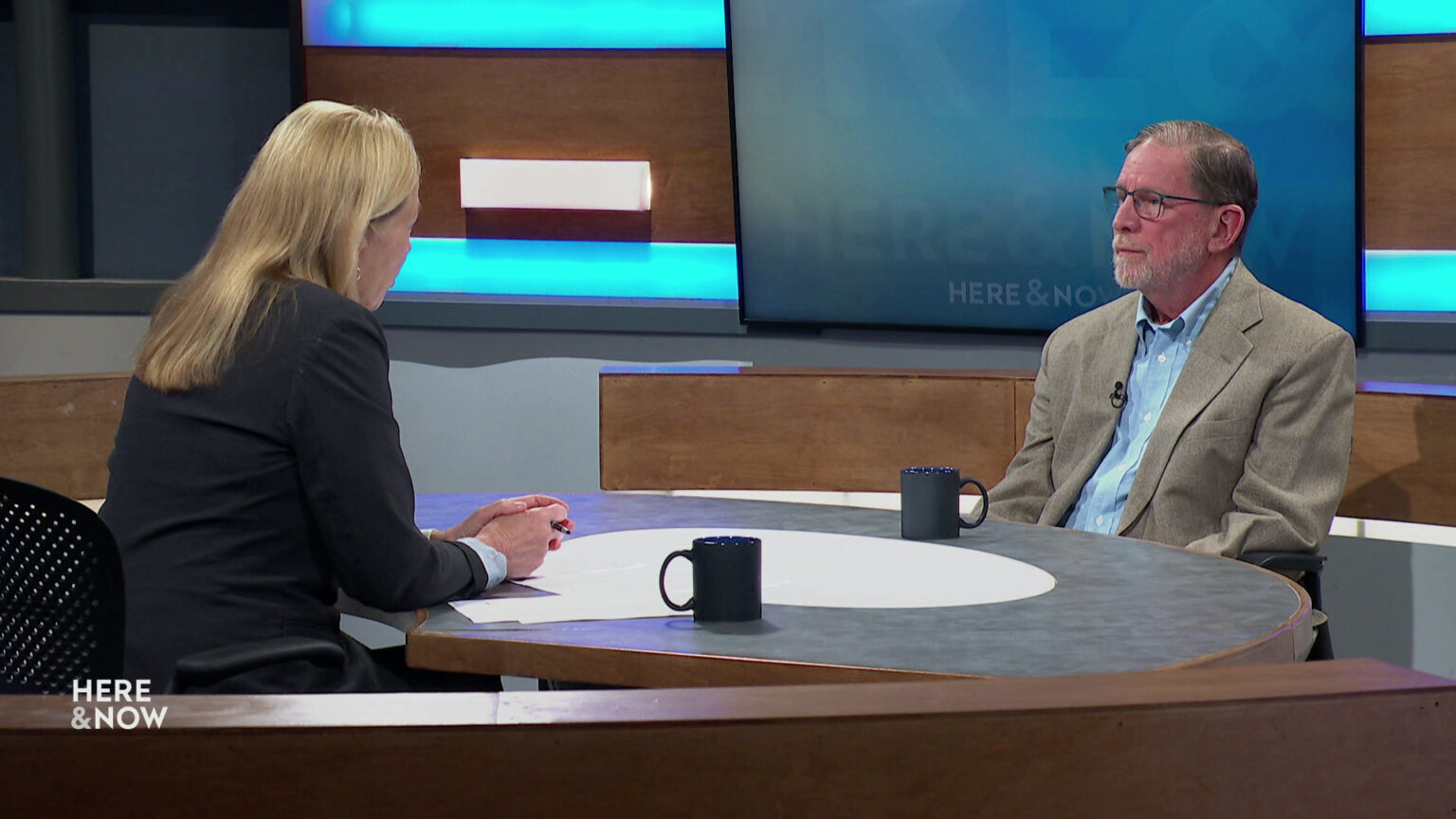 Frederica Freyberg and Dr. Michael Siebers sit facing each other on the Here & Now set. Frederica Freyberg and Dr. Michael Siebers sit facing each other on the Here & Now set.