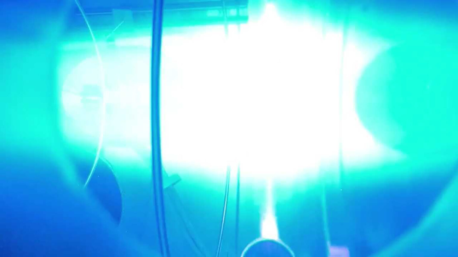 Bright light created by an experimental nuclear fusion device illuminates equipment surrounding the location of the reaction.