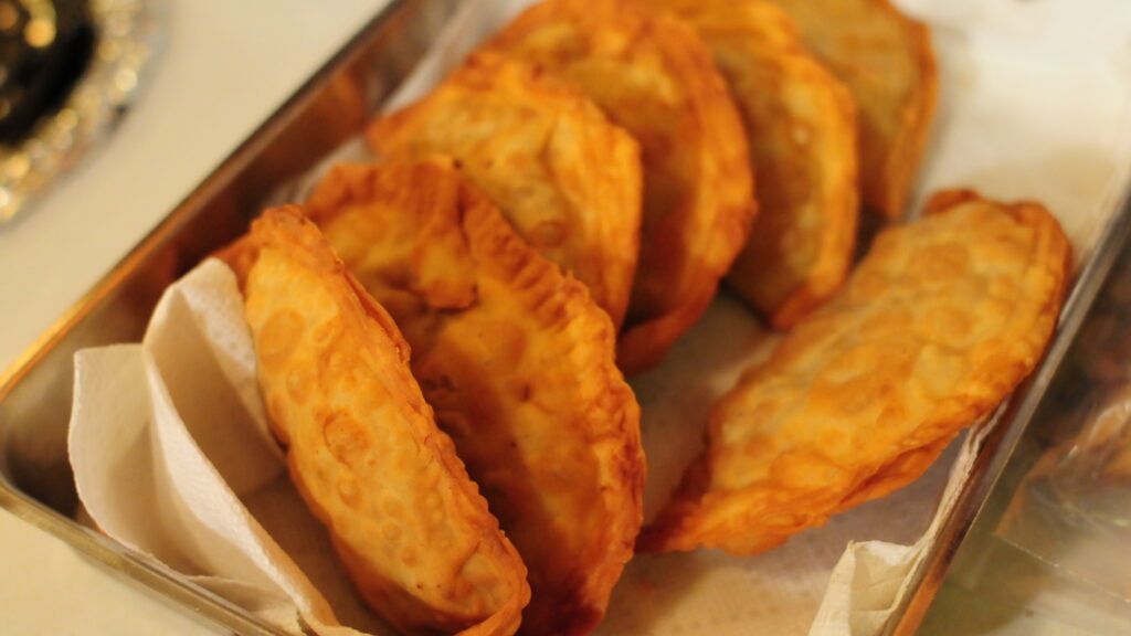 A stack of old-fashioned applejacks bunched together on their side, in a small sheet pan.