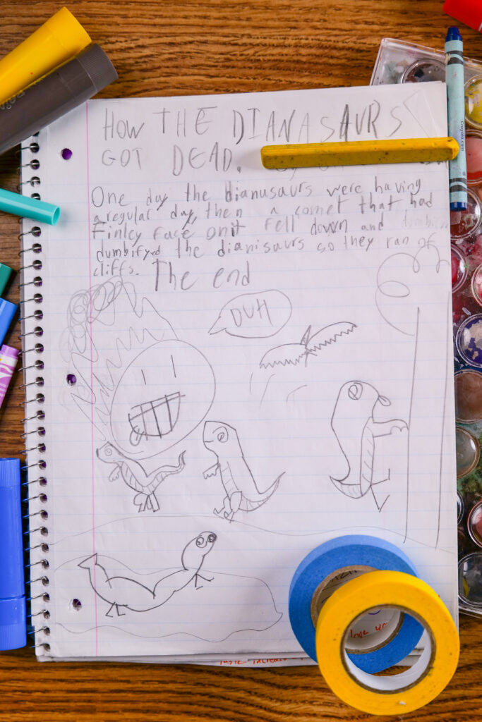 A notebook with a child's funny story about how the dinosaurs died.
