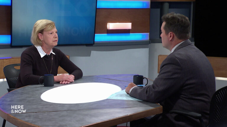 Tammy Baldwin and Zac Schultz sit facing each other on the Here & Now set.