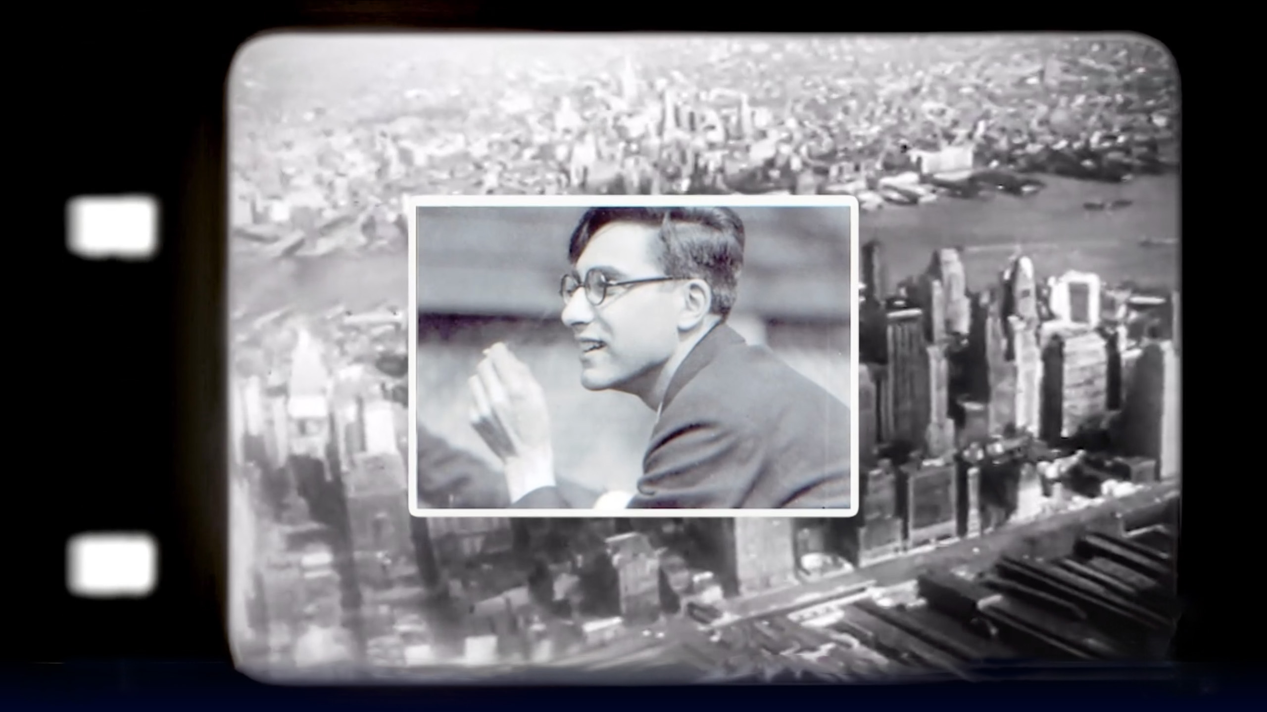 Black-and-white collage showing an aerial view of New York City framed by the perforated edge of film stock, overlaid with a smaller photo of a man in glasses and a suit speaking in profile.