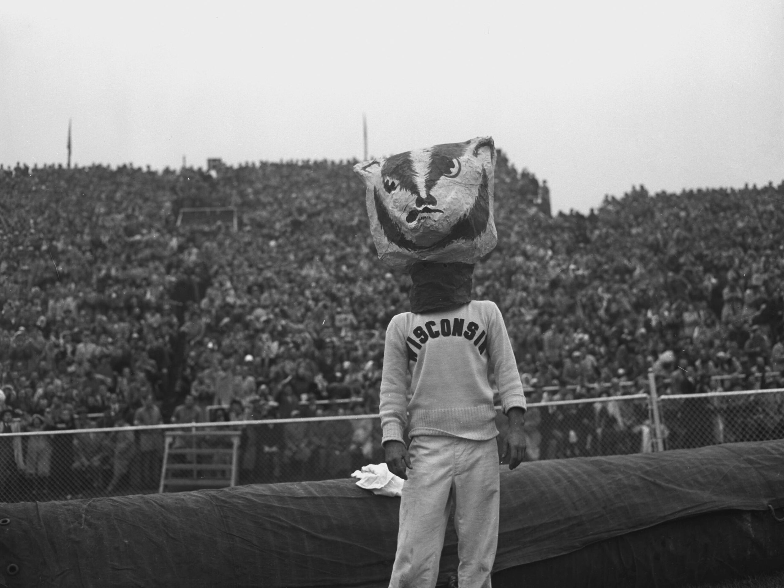 At the 1949 Homecoming Wisconsin-Iowa football game, a cheerleader wears the "Bucky Badger" head at Camp Randall Stadium.