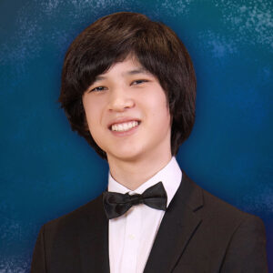 A portrait of André Peck in a suit and bow tie.