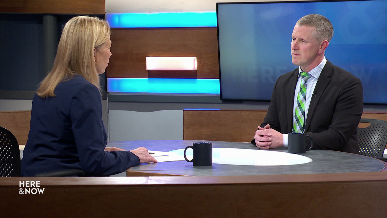 Frederica Freyberg and Jeff Wright sit facing each other on the Here & Now set. Frederica Freyberg and Jeff Wright sit facing each other on the Here & Now set.