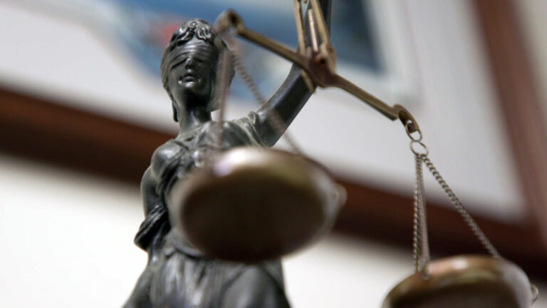 A desk statue of Lady Justice is displayed in an office at the Waushara County Courthouse on Nov. 14, 2022, in Wautoma. (Credit: PBS Wisconsin)