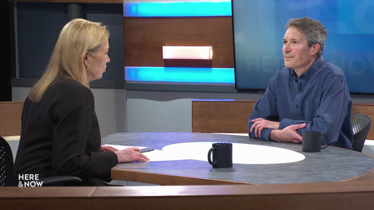 Frederica Freyberg and Steve Vavrus sit facing each other on the Here & Now set.
