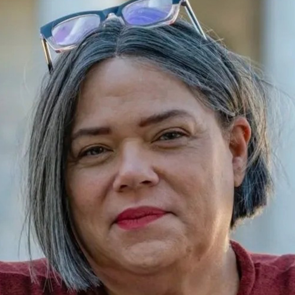 Dina Nina Martinez-Rutherford poses for a portrait.