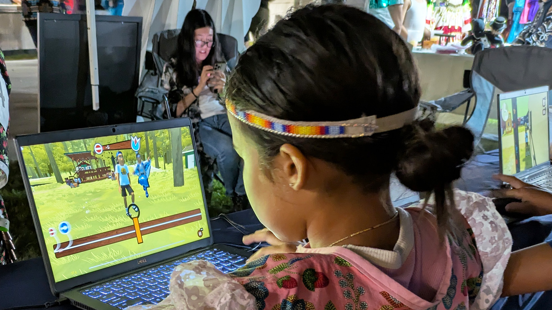 Photo of a child in regalia playing Powwow Bound at the Menominee Annual Contest Powwow. (Source: PBS Wisconsin)