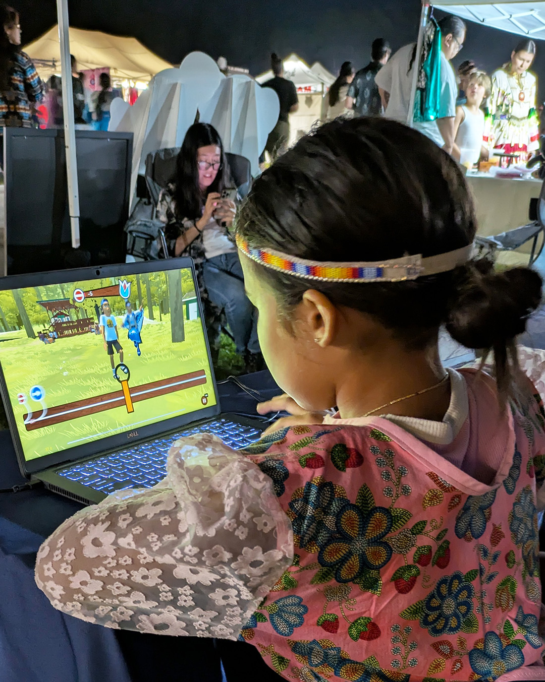 Photo of a child in regalia playing Powwow Bound at the Menominee Annual Contest Powwow. (Source: PBS Wisconsin)
