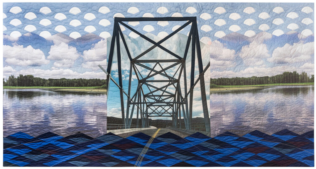 A collage, pictorial quilt with a depiction of the Wabasha Bridge over the Mississippi River in the center.